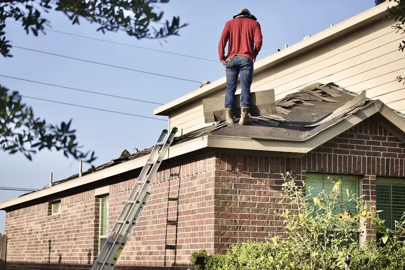 Professional roofer working on a residential roof in Frenchman's Reserve